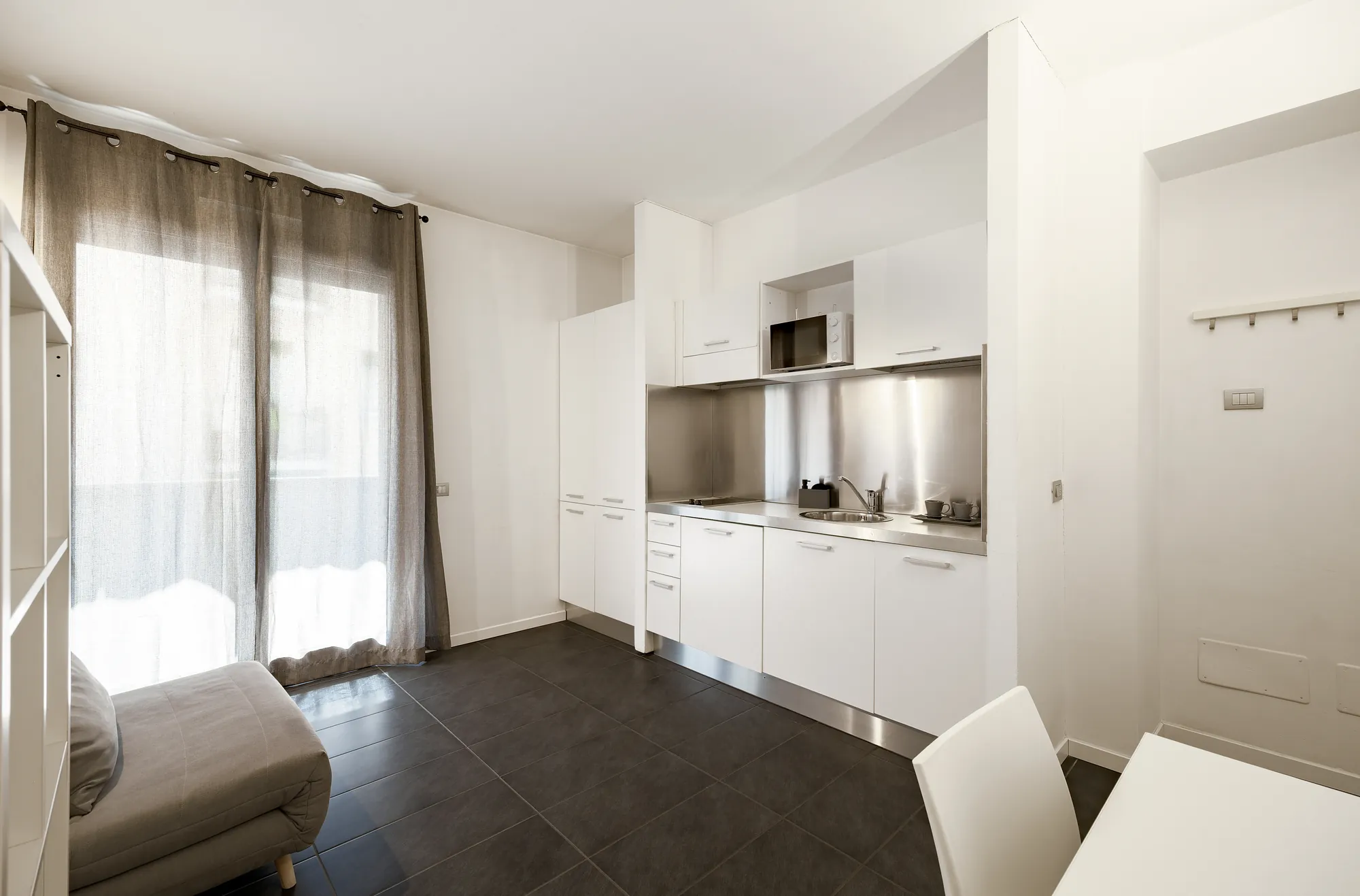 Appartamento Standard Plus: soggiorno con cucina e tavolo da pranzo